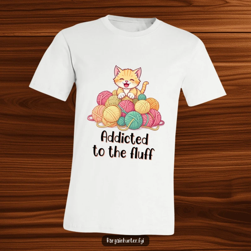Funny kitten t-shirt depicting a gleeful kitten joyfully pouncing on a large pile of discounted yarn balls.